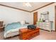 Bedroom with ceiling fan, wood trim, bed, and dresser with mirror at 4800 Silverberry Nw Ln, Acworth, GA 30102