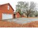 Rustic wood-sided home with an attached two-car garage, mature trees, and a concrete driveway at 4800 Silverberry Nw Ln, Acworth, GA 30102