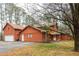 Rustic home with attached two-car garage, mature trees, a quaint front porch, and an extended driveway at 4800 Silverberry Nw Ln, Acworth, GA 30102