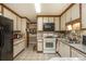 Kitchen showcasing white cabinets, a black refrigerator, and tile flooring at 4800 Silverberry Nw Ln, Acworth, GA 30102