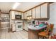 Cozy kitchen featuring light cabinets, a breakfast bar, and a gas range at 4800 Silverberry Nw Ln, Acworth, GA 30102