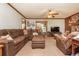 Cozy living room featuring a large sectional sofa, a stone fireplace, and wood trim at 4800 Silverberry Nw Ln, Acworth, GA 30102