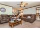 Living room featuring carpet, a ceiling fan, and comfortable seating at 4800 Silverberry Nw Ln, Acworth, GA 30102