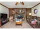 Living room featuring a stone fireplace, wood paneling, and a mounted television at 4800 Silverberry Nw Ln, Acworth, GA 30102