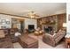 Cozy living room featuring a stone fireplace, wood paneling, and comfortable seating at 4800 Silverberry Nw Ln, Acworth, GA 30102