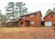 Two-story home exterior with a covered porch, showcasing its architectural design and backyard at 4800 Silverberry Nw Ln, Acworth, GA 30102