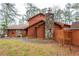 Rustic wood-sided home featuring a stone chimney, a quaint front porch, and mature trees at 4800 Silverberry Nw Ln, Acworth, GA 30102