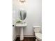Charming powder room with pedestal sink, oval mirror, and modern toilet at 1196 Wylie Se St, Atlanta, GA 30316