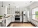 Well-lit kitchen with white cabinets, stainless steel appliances, and modern fixtures at 1196 Wylie Se St, Atlanta, GA 30316