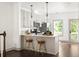 Bright kitchen features modern cabinets, stainless steel appliances, countertop seating and beautiful wood floors at 1196 Wylie Se St, Atlanta, GA 30316
