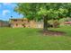 View of a home's backyard with expansive lawn and mature trees, offering privacy at 3332 Oak Grove Rd, Loganville, GA 30052