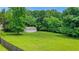 Expansive backyard featuring lush greenery and a detached two-car garage at 3332 Oak Grove Rd, Loganville, GA 30052