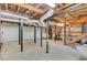 Spacious basement featuring concrete flooring and exposed wooden ceiling beams at 3332 Oak Grove Rd, Loganville, GA 30052