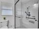 Modern bathroom features a tiled walk-in shower with a glass enclosure and sleek fixtures at 3332 Oak Grove Rd, Loganville, GA 30052