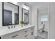 Updated bathroom features a double sink vanity, stylish fixtures, and tile floors at 3332 Oak Grove Rd, Loganville, GA 30052