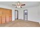 Spacious bedroom featuring plush carpeting, a ceiling fan and double door closet at 3332 Oak Grove Rd, Loganville, GA 30052