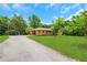 Charming one-story home with brick facade, well-manicured lawn, and gravel driveway at 3332 Oak Grove Rd, Loganville, GA 30052