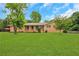 Charming brick home with a well-manicured lawn and mature trees, creating a welcoming curb appeal at 3332 Oak Grove Rd, Loganville, GA 30052