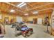 Large two car garage interior with high ceiling, lighting, storage and lawn care equipment at 3332 Oak Grove Rd, Loganville, GA 30052