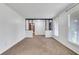 Open-concept living room with neutral decor, carpeted floors, and abundant natural light at 3332 Oak Grove Rd, Loganville, GA 30052