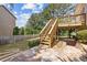 Backyard of home featuring deck, stairs, lush green grass and manicured landscaping at 11100 Chandon Way, Johns Creek, GA 30097