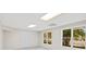 Finished basement area with neutral paint and carpet, windows and outside views at 11100 Chandon Way, Johns Creek, GA 30097