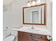 Bright bathroom featuring a wood vanity with a large framed mirror and tiled shower at 11100 Chandon Way, Johns Creek, GA 30097