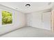 Bright bedroom with neutral carpet and paint, with a window overlooking the yard at 11100 Chandon Way, Johns Creek, GA 30097