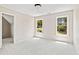 Neutral bedroom featuring two windows with views of trees and lush greenery at 11100 Chandon Way, Johns Creek, GA 30097