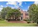 Charming two-story brick home showcasing manicured landscaping and a lush, green lawn in a desirable neighborhood at 11100 Chandon Way, Johns Creek, GA 30097
