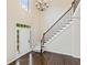 Bright foyer features a staircase with decorative iron railing and hardwood floors at 11100 Chandon Way, Johns Creek, GA 30097