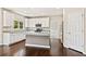 Beautiful kitchen with white cabinets, granite countertops, stainless steel appliances and a center island at 11100 Chandon Way, Johns Creek, GA 30097