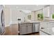 Open kitchen with granite countertops and a view into the great room with fireplace and vaulted ceiling at 11100 Chandon Way, Johns Creek, GA 30097