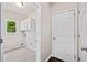 Functional laundry room with tiled flooring, window, and upper cabinets, plus access to the garage at 11100 Chandon Way, Johns Creek, GA 30097