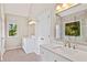 Bright main bathroom featuring dual vanities, mirrors, natural light, and modern lighting fixtures at 11100 Chandon Way, Johns Creek, GA 30097