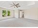 Spacious main bedroom with a ceiling fan, trey ceiling, and large windows for natural light at 11100 Chandon Way, Johns Creek, GA 30097