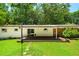 Backyard showcasing a spacious deck, well-maintained lawn, and access to the house through sliding glass doors at 1492 Sagewood Cir, Stone Mountain, GA 30083