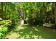 Backyard view featuring a storage shed surrounded by lush greenery, ideal for outdoor projects at 1492 Sagewood Cir, Stone Mountain, GA 30083