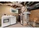 Unfinished basement utility area with washer, dryer, laundry sink, and furnace at 1492 Sagewood Cir, Stone Mountain, GA 30083