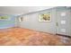 Finished basement featuring tile floors, two windows and a glass paneled door at 1492 Sagewood Cir, Stone Mountain, GA 30083