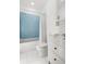 Bright bathroom featuring a bathtub with blue tile and white vanity at 1492 Sagewood Cir, Stone Mountain, GA 30083