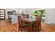 Open-concept dining area next to a kitchen with hardwood floors and a glass-top table with seating for six at 1492 Sagewood Cir, Stone Mountain, GA 30083