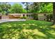 Well-manicured lawn and lush greenery surrounding a charming one-story home at 1492 Sagewood Cir, Stone Mountain, GA 30083