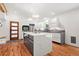 Modern kitchen features an island with a marble countertop, stainless steel appliances, and hardwood floors at 1492 Sagewood Cir, Stone Mountain, GA 30083