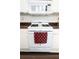 Close up of a white gas stove with a red checkered towel and white microwave at 2840 General Lee Way, Buford, GA 30519