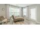 Bright bedroom featuring two large windows, wood flooring, and modern chair and chaise lounge at 4228 Laurel Creek Se Ct # 6, Smyrna, GA 30080