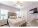 Inviting bedroom with a comfortable bed, a ceiling fan, and a mounted television at 4228 Laurel Creek Se Ct # 6, Smyrna, GA 30080