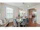 Stylish dining area featuring modern chandelier, table seating, and rich hardwood floors at 4228 Laurel Creek Se Ct # 6, Smyrna, GA 30080
