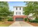 Traditional two-story house with brick base, white siding, dark shutters, and a driveway to the garage at 4228 Laurel Creek Se Ct # 6, Smyrna, GA 30080