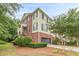 Charming brick and siding townhome with a two-car garage and manicured landscaping at 4228 Laurel Creek Se Ct # 6, Smyrna, GA 30080